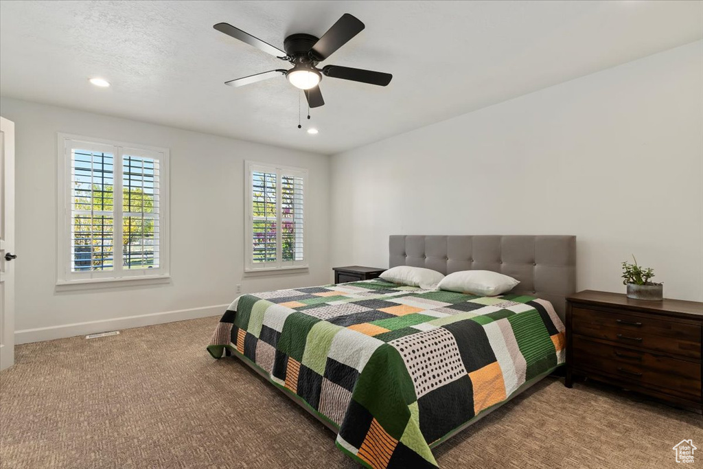 Carpeted bedroom with ceiling fan, baseboards, and recessed lighting