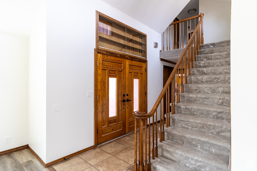 Foyer entrance featuring baseboards and stairs