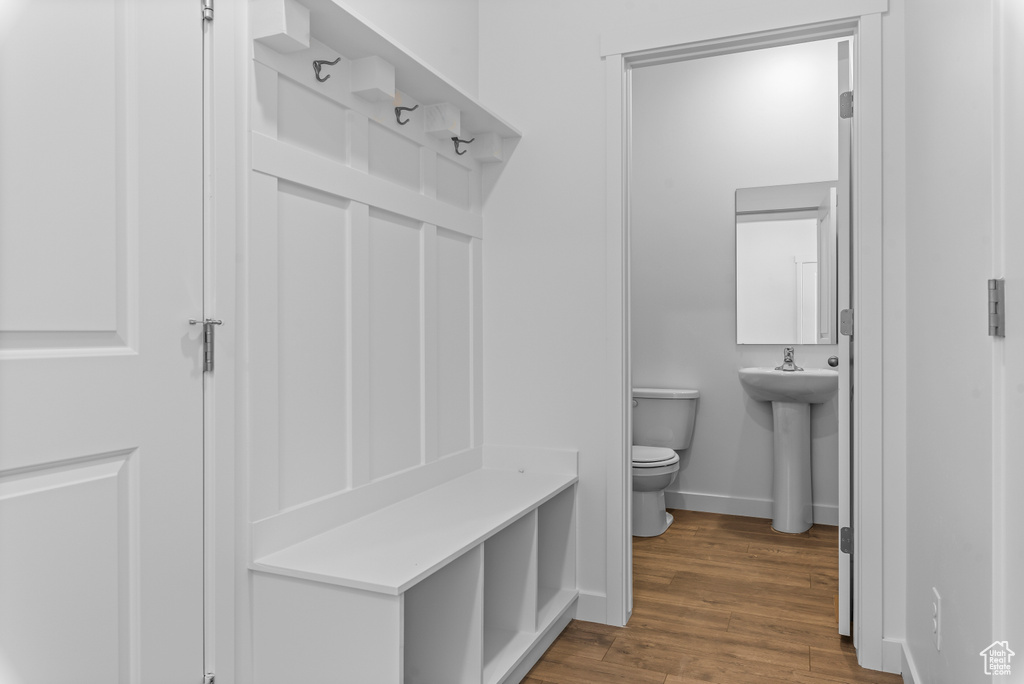 Mudroom with baseboards and wood finished floors