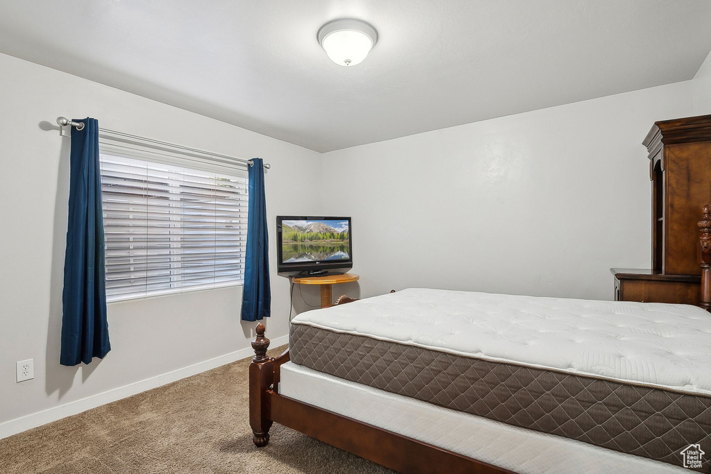 Carpeted bedroom featuring baseboards