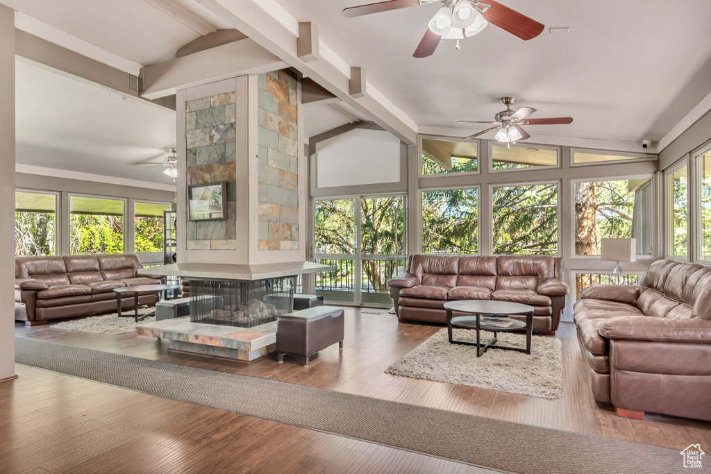 Interior space featuring high vaulted ceiling, beamed ceiling, and hardwood / wood-style flooring