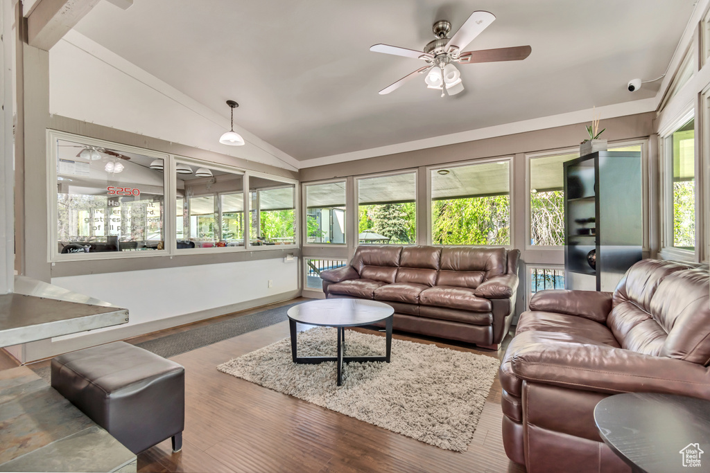 Living room featuring wood finished floors, ceiling fan, and vaulted ceiling
