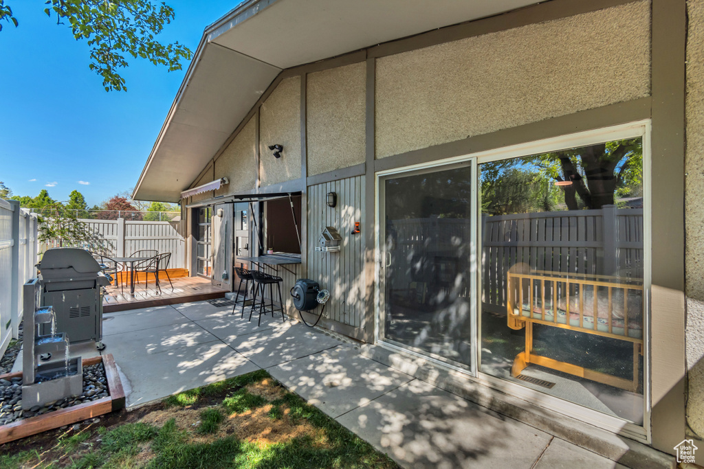 View of patio featuring area for grilling and fence