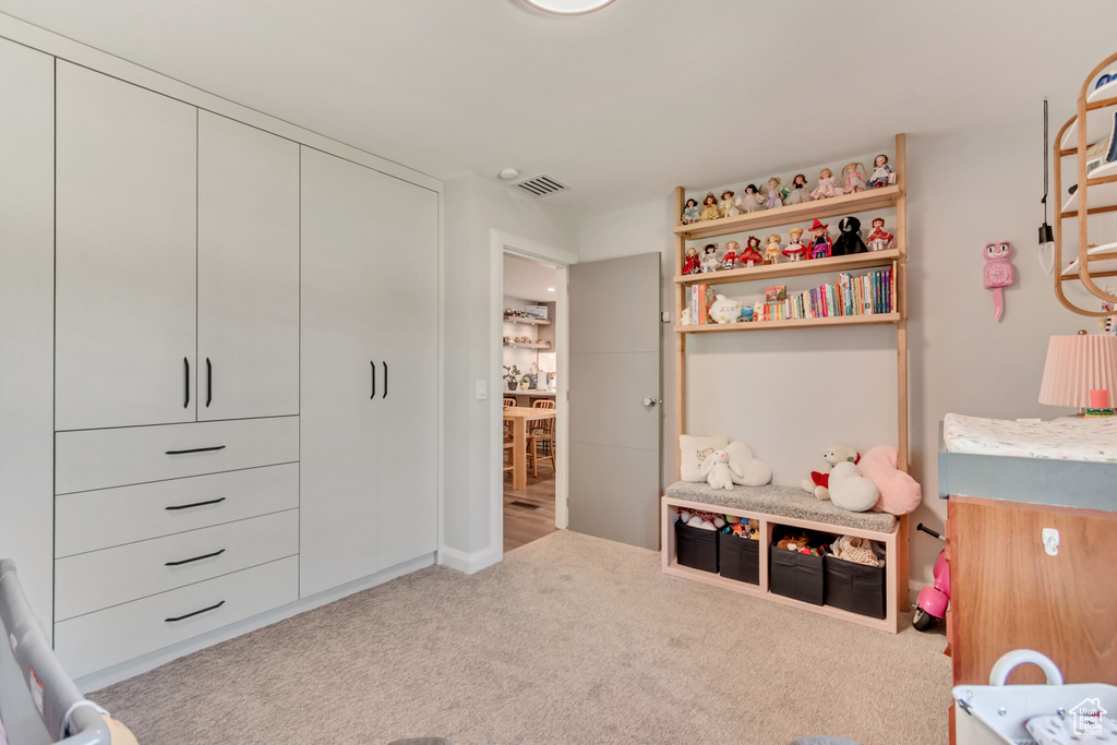 Bedroom with a closet, visible vents, and carpet floors