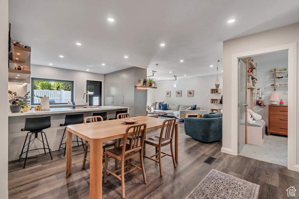 Dining room with recessed lighting, visible vents, and wood finished floors
