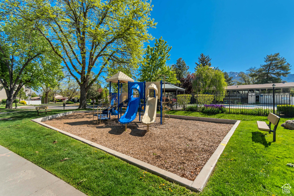Community play area featuring a yard and fence