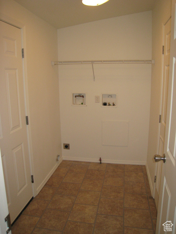 Washroom with baseboards, washer hookup, hookup for a gas dryer, hookup for an electric dryer, and laundry area
