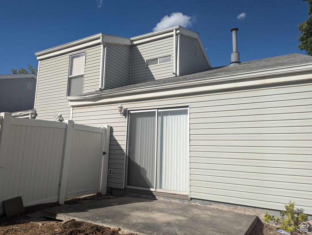 View of side of home with fence