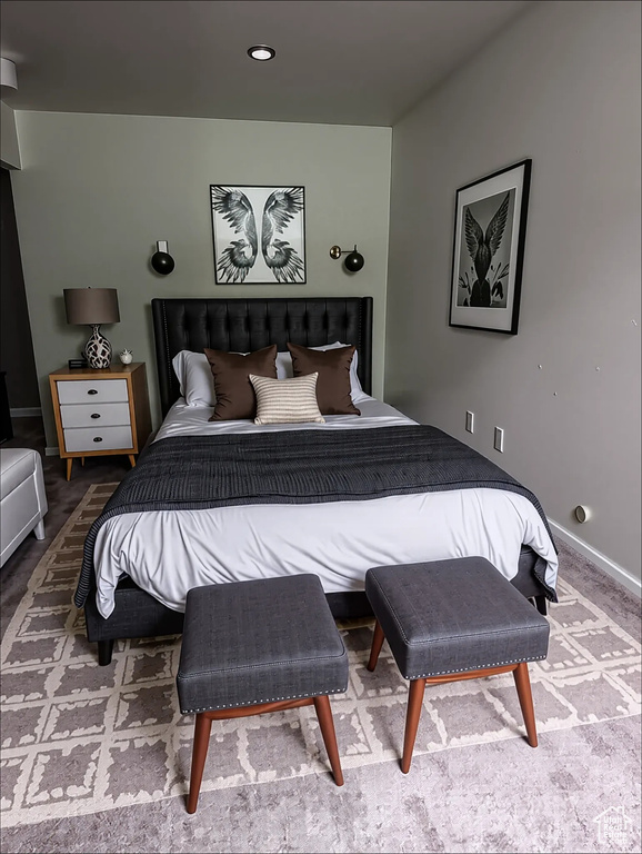 Carpeted bedroom featuring baseboards