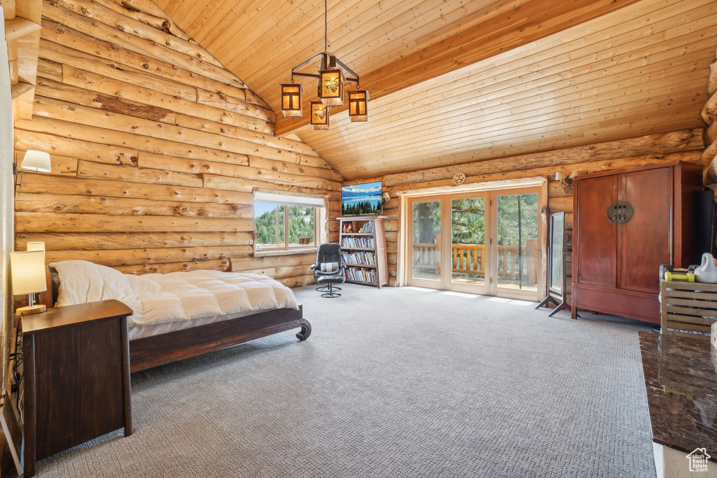 Carpeted bedroom with wood ceiling, high vaulted ceiling, multiple windows, and access to exterior