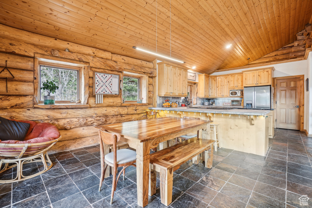 Dining room with wooden ceiling, log walls, lofted ceiling, and stone tile flooring