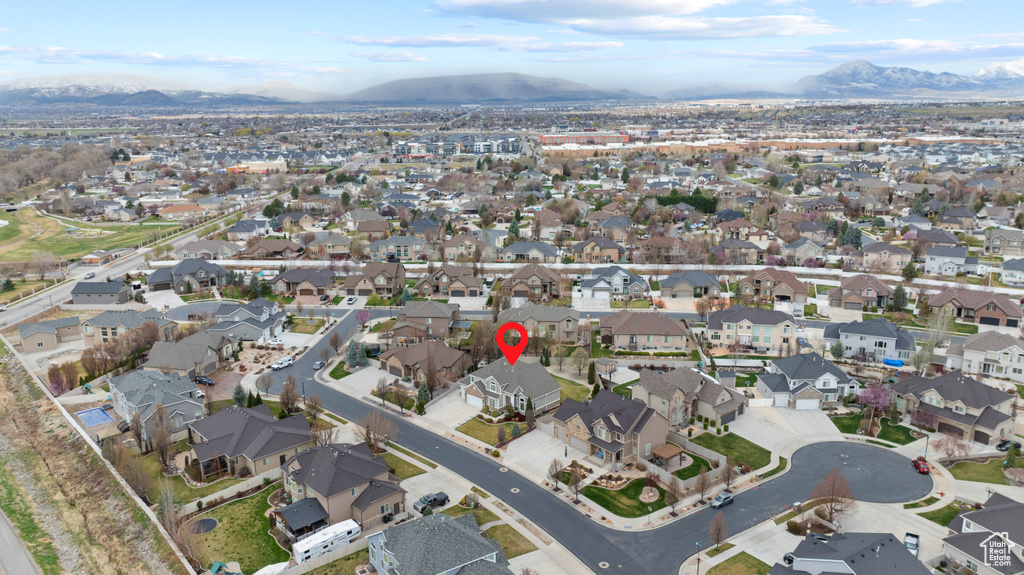 Birds eye view of property with a mountain view and a residential view