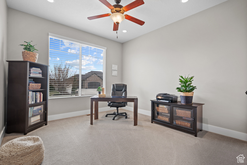 Office space featuring baseboards, a ceiling fan, and carpet floors