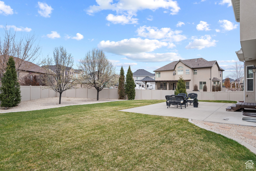 View of yard featuring a fenced backyard, a patio area, and a residential view
