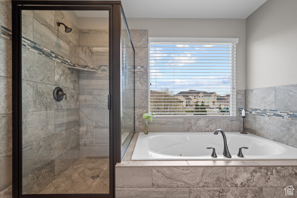 Bathroom with a garden tub and a shower stall