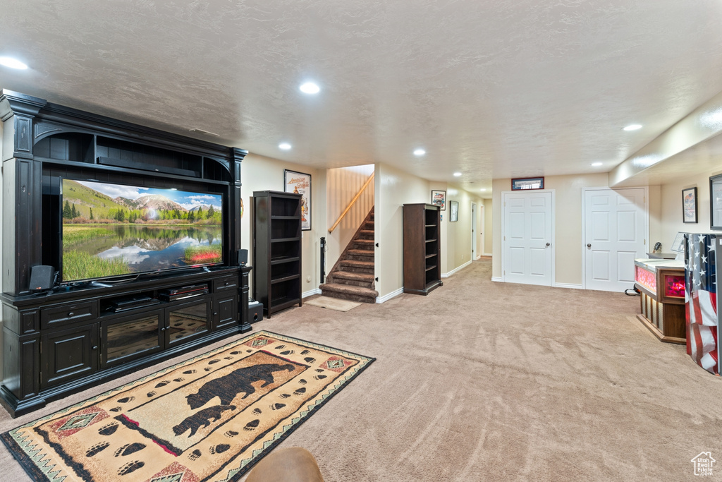 Living room with carpet, recessed lighting, stairway, and baseboards