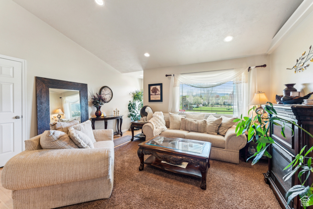 Living room featuring recessed lighting, vaulted ceiling, and carpet floors