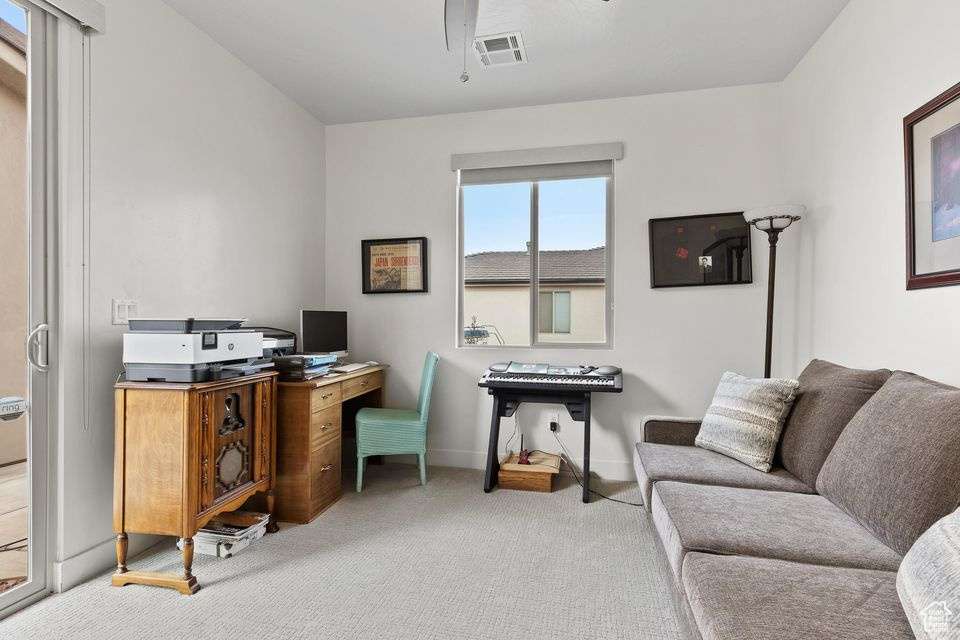 Office with carpet flooring, ceiling fan, and baseboards