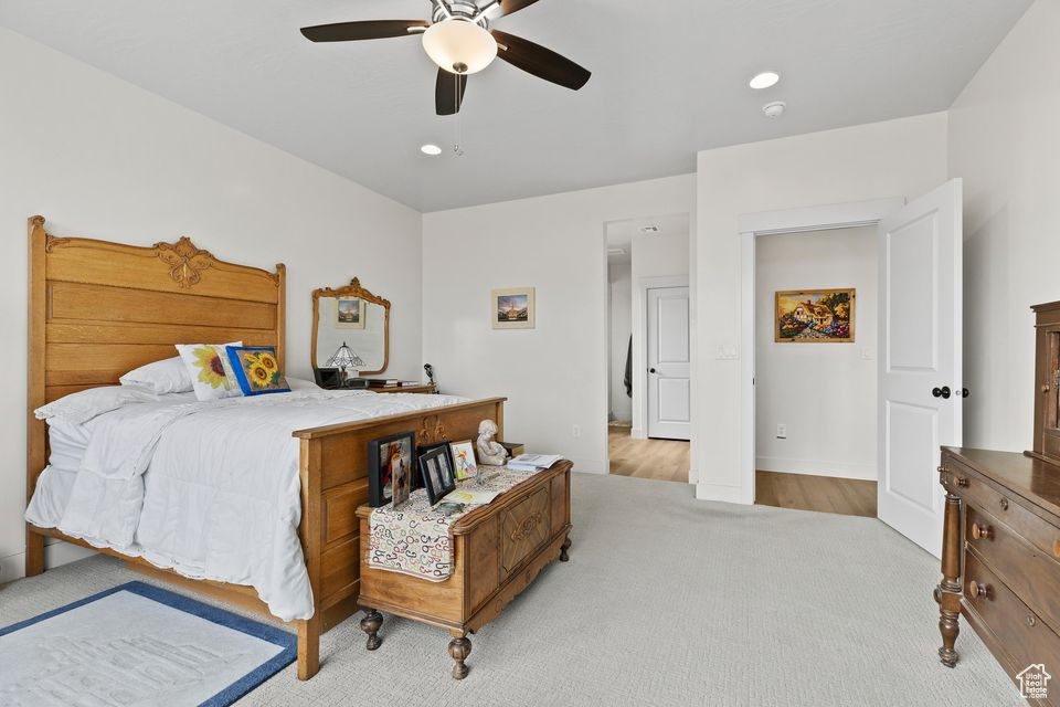 Carpeted bedroom featuring a ceiling fan, baseboards, and recessed lighting