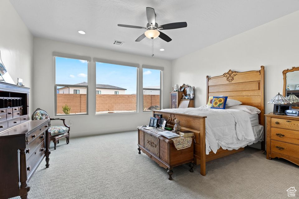 Bedroom with carpet flooring, ceiling fan, and recessed lighting