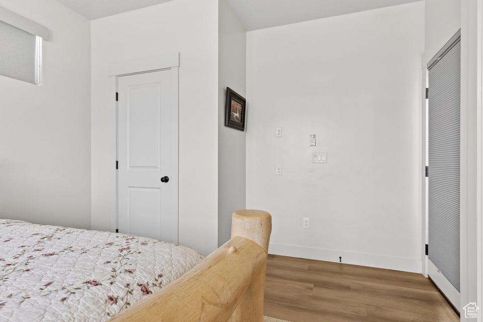 Bedroom featuring wood finished floors and baseboards