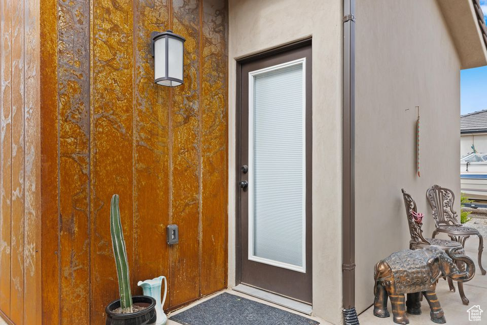 View of exterior entry featuring stucco siding