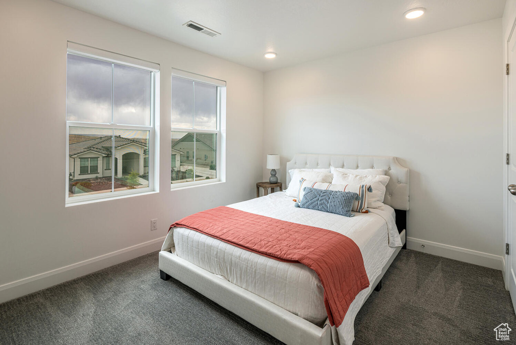 Bedroom featuring carpet floors, baseboards, and visible vents