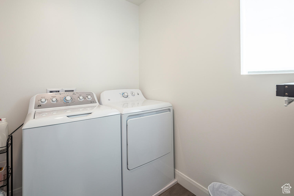 Laundry area featuring baseboards, laundry area, and washer and clothes dryer