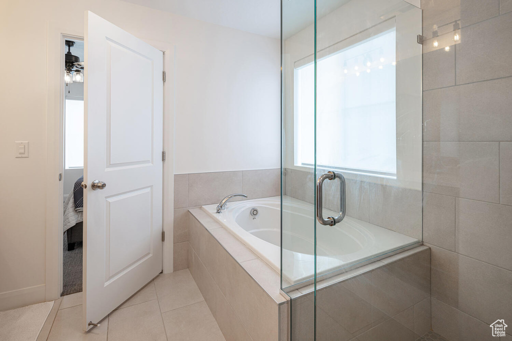 Bathroom featuring tile patterned floors and a bath