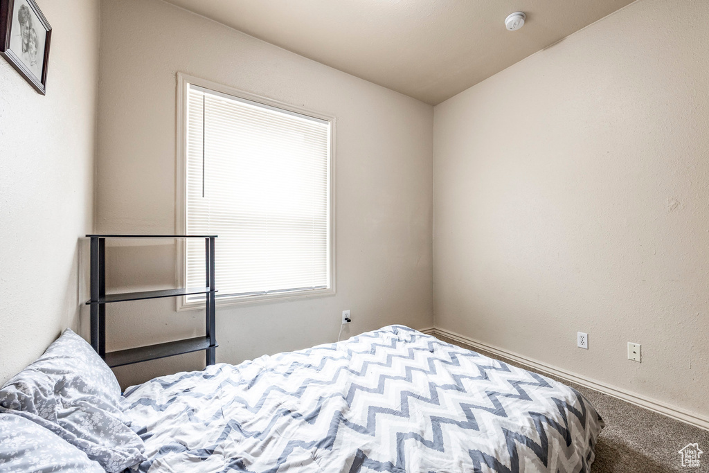 Bedroom featuring carpet flooring and baseboards