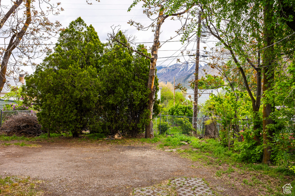 Exterior space featuring a mountain view and fence