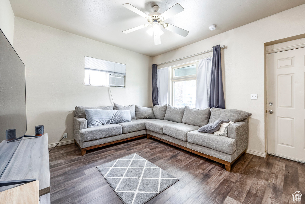 Living room featuring ceiling fan, baseboards, and wood finished floors