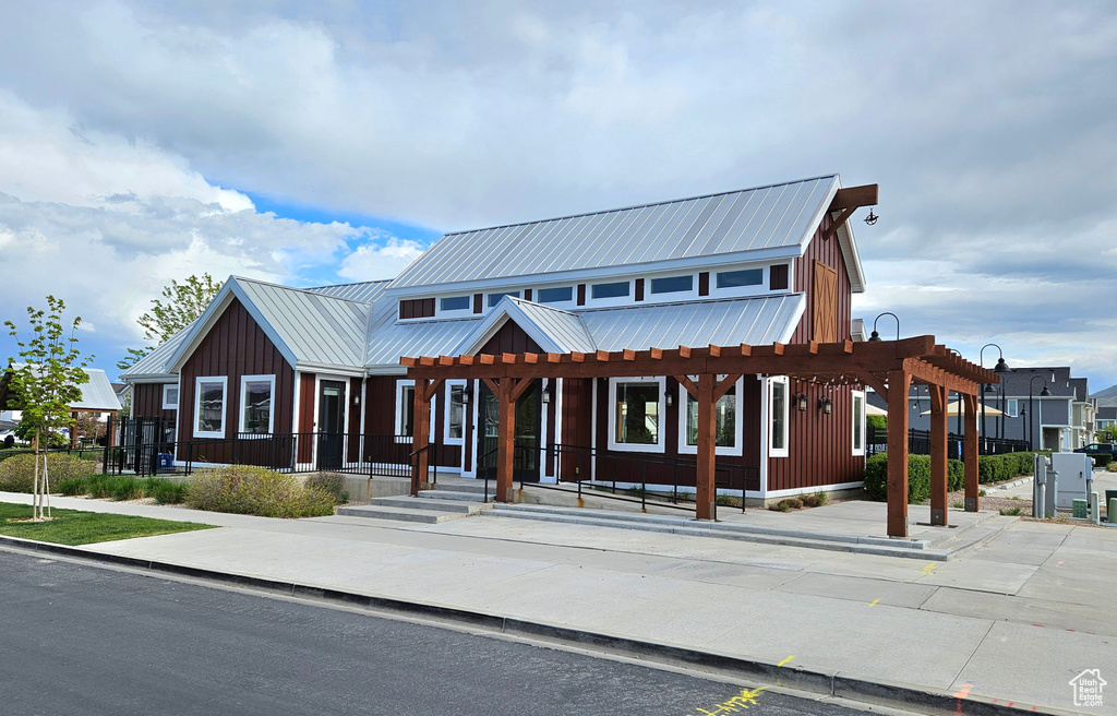 View of front of property featuring board and batten siding and metal roof