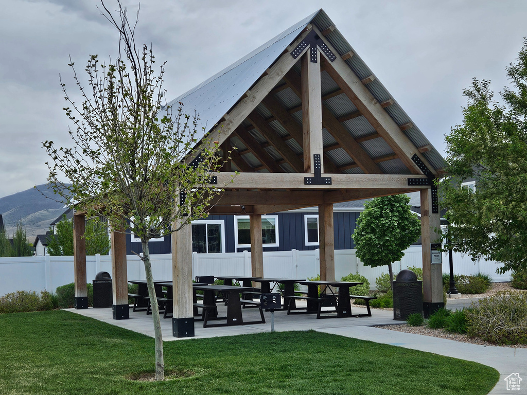 View of home\\\'s community with fence, a gazebo, and a lawn