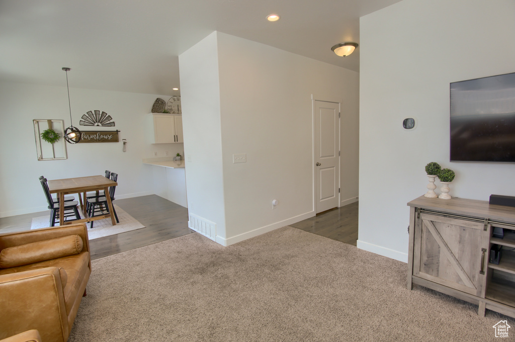 Living area featuring baseboards, carpet flooring, visible vents, and recessed lighting