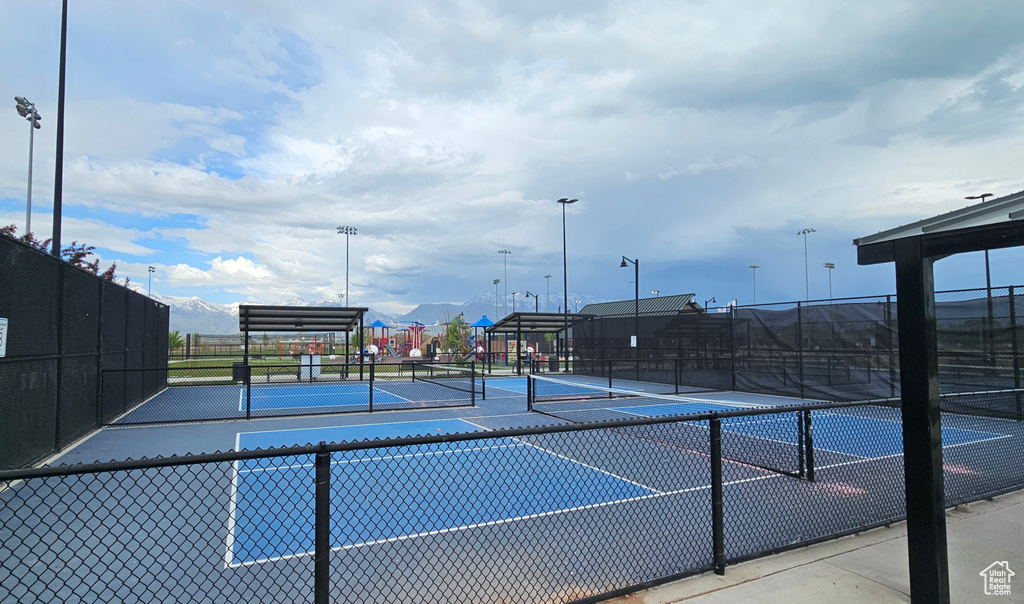 View of tennis court featuring fence