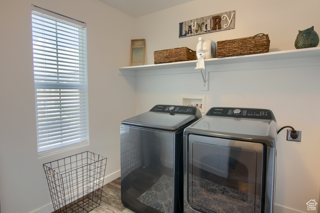 Laundry room featuring baseboards, laundry area, independent washer and dryer, and wood finished floors
