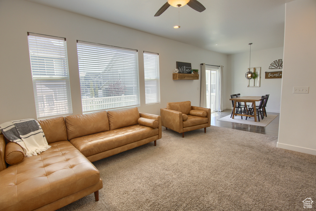 Living room with a ceiling fan, baseboards, recessed lighting, and carpet