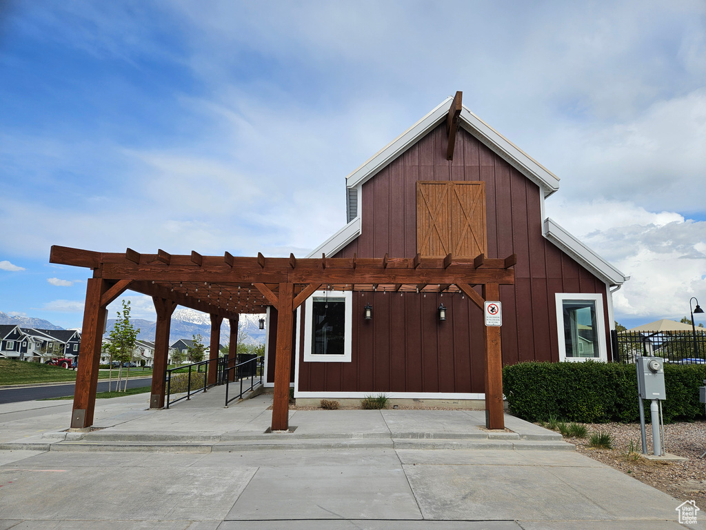 View of community with a pergola and fence