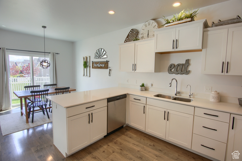 Kitchen featuring a sink, recessed lighting, white cabinetry, and dishwasher