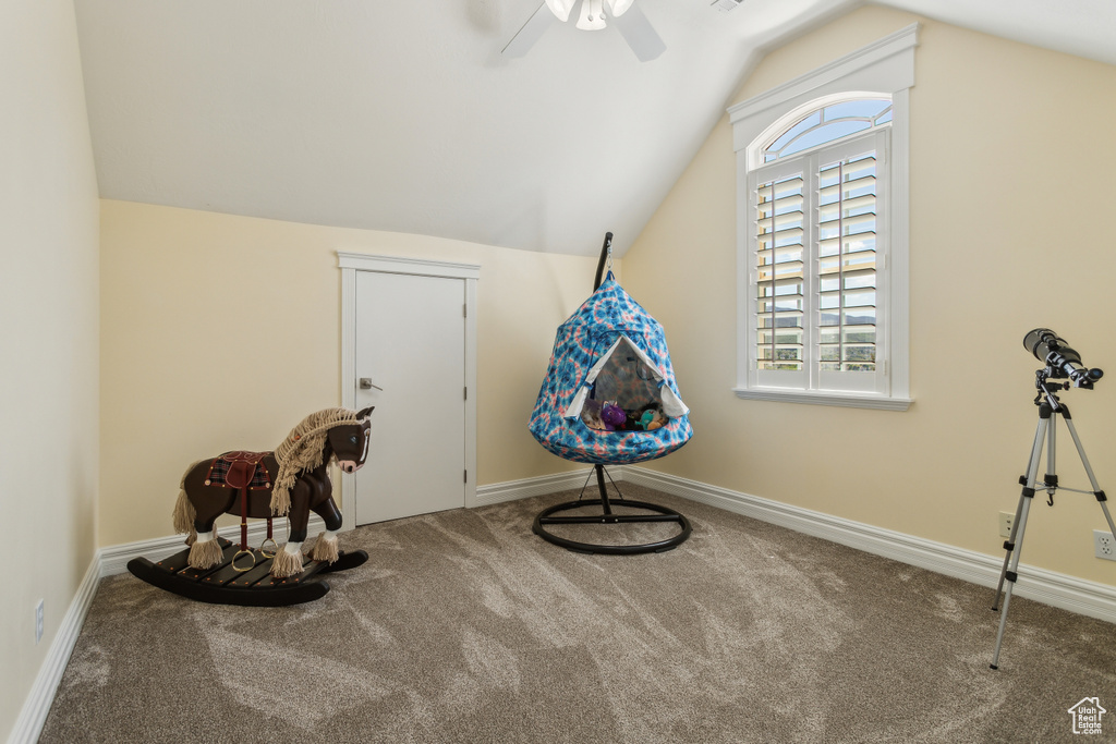 Playroom with baseboards, carpet flooring, a ceiling fan, and lofted ceiling