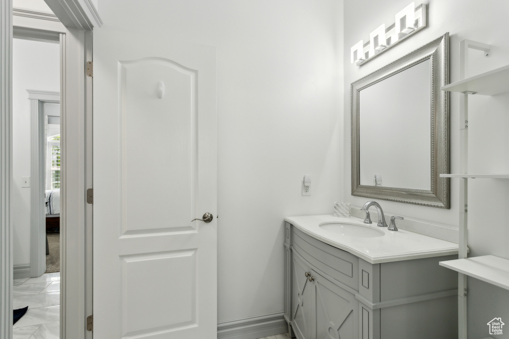 Bathroom featuring vanity and marble finish floor