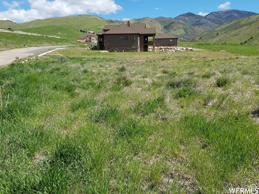 Property view of mountains with a rural view