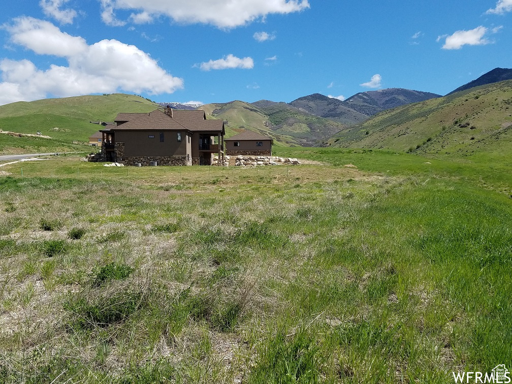Property view of mountains with a rural view