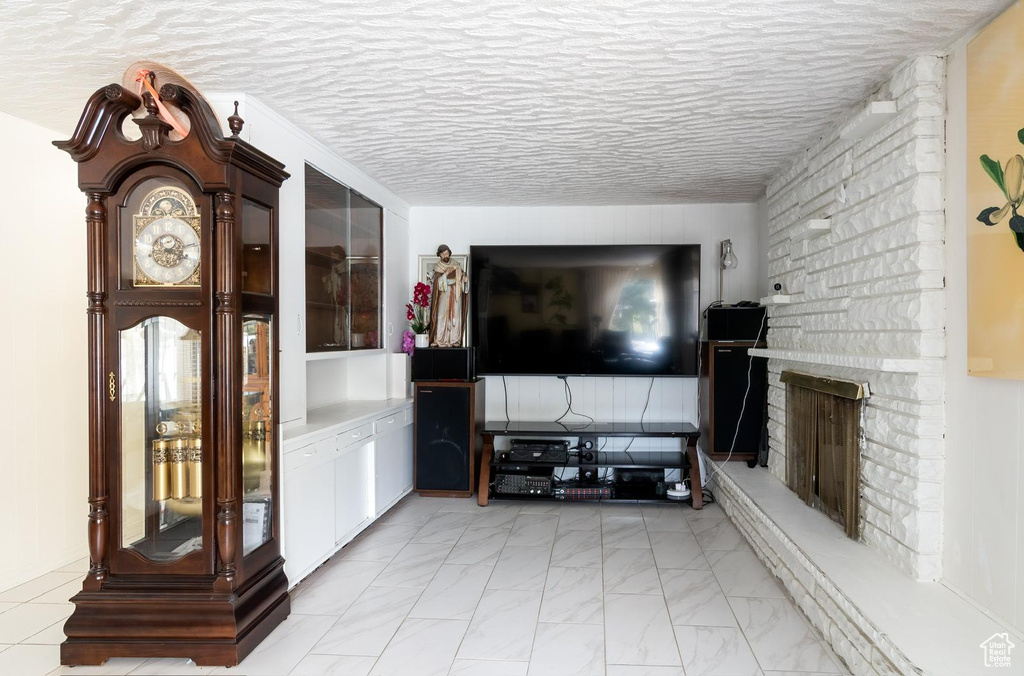 Living area featuring marble finish floor and a fireplace