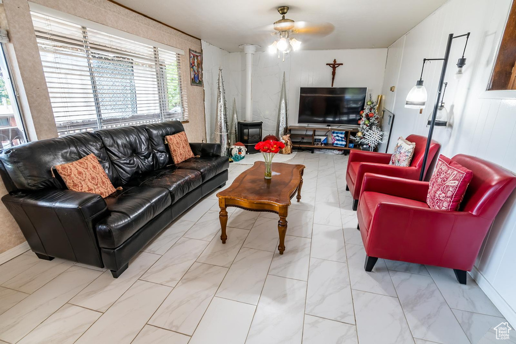 Living room with a ceiling fan and marble finish floor
