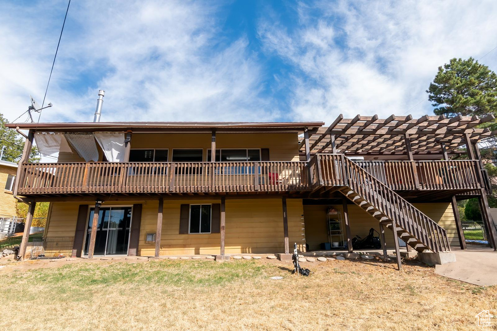 Back of property featuring stairway and a wooden deck