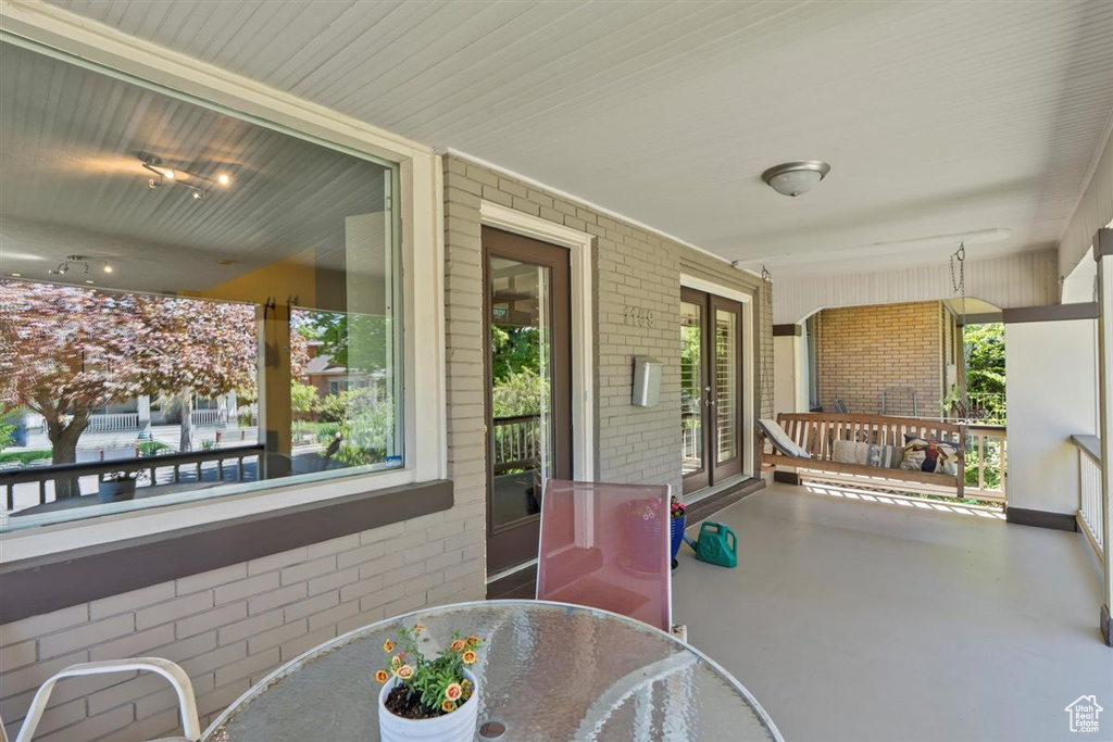 View of patio featuring outdoor dining space and a porch