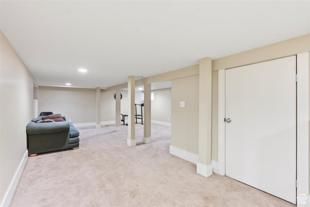 Finished below grade area with baseboards and light carpet
