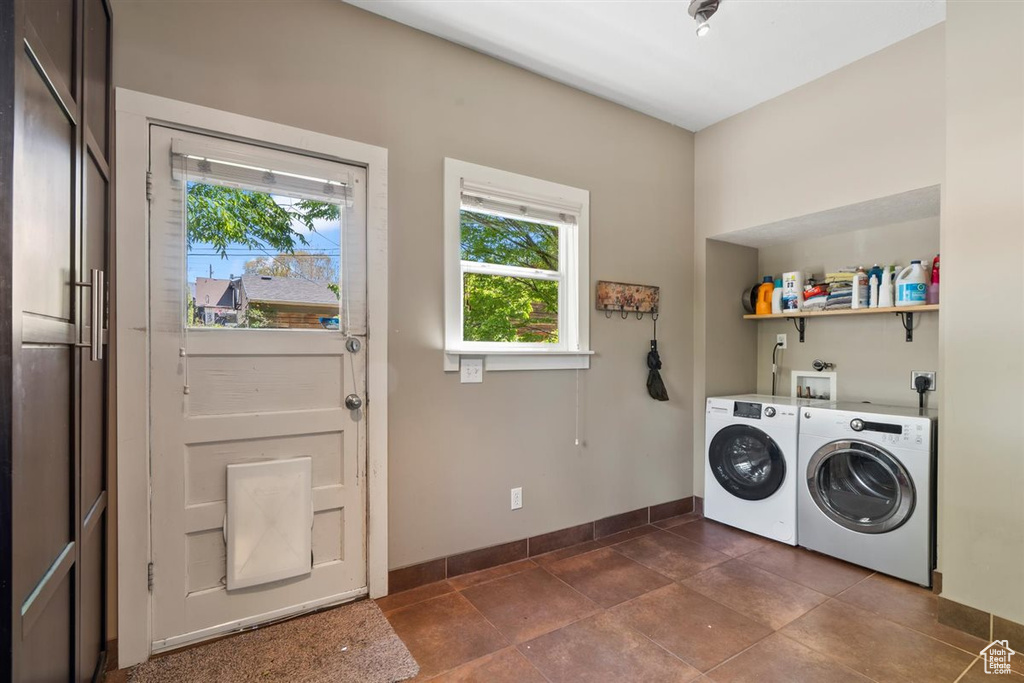 Laundry room with baseboards, laundry area, and washer and dryer